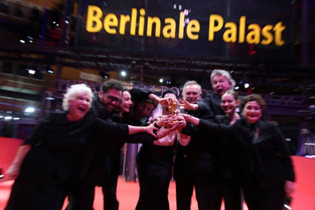 February 21, 2026, Berlin, Germany: Ilker Catak, with cast and crew pose with the Golden Bear for Best Film for Gelbe Briefe (Yellow Letters) after the closing ceremony of the 76th Berlin International Film Festival (Berlinale), Europe s first major film festival of the year, in Berlin. The festival runs from February 12 to 22, 2026. Berlin Germany - ZUMAf146 20260221_zip_f146_007 Copyright: xRouzbehxFouladix