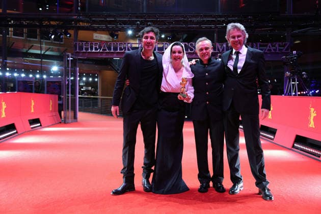 February 21, 2026, Berlin, Germany: Ilker Catak, with cast and crew pose with the Golden Bear for Best Film for Gelbe Briefe (Yellow Letters) after the closing ceremony of the 76th Berlin International Film Festival (Berlinale), Europe s first major film festival of the year, in Berlin. The festival runs from February 12 to 22, 2026. Berlin Germany - ZUMAf146 20260221_zip_f146_008 Copyright: xRouzbehxFouladix