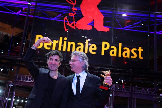 February 21, 2026, Berlin, Germany: German film director and screenwriter Ilker Catak (L) and Movie producer Ingo Fliess pose with the Golden Bear for Best Film for Gelbe Briefe (Yellow Letters) after the closing ceremony of the 76th Berlin International Film Festival (Berlinale), Europe s first major film festival of the year, in Berlin. The festival runs from February 12 to 22, 2026. Berlin Germany - ZUMAf146 20260221_zip_f146_013 Copyright: xRouzbehxFouladix