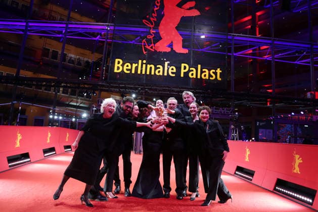February 21, 2026, Berlin, Germany: Ilker Catak, with cast and crew pose with the Golden Bear for Best Film for Gelbe Briefe (Yellow Letters) after the closing ceremony of the 76th Berlin International Film Festival (Berlinale), Europe s first major film festival of the year, in Berlin. The festival runs from February 12 to 22, 2026. Berlin Germany - ZUMAf146 20260221_zip_f146_019 Copyright: xRouzbehxFouladix