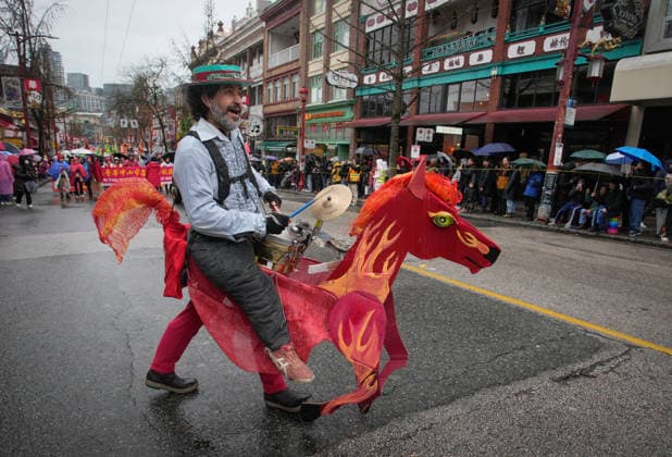(260223) -- VANCOUVER, Feb. 23, 2026 -- A musician in a horse-shaped costume performs during a Spring Festival parade at Chinatown in Vancouver, British Columbia, Canada, on Feb. 22, 2026. The 52nd annual Vancouver Chinatown Spring Festival Parade was held here on Sunday to celebrate the Chinese Year of the Horse. (Photo by Xinhua) CANADA-VANCOUVER-SPRING FESTIVAL PARADE LiangxSen 