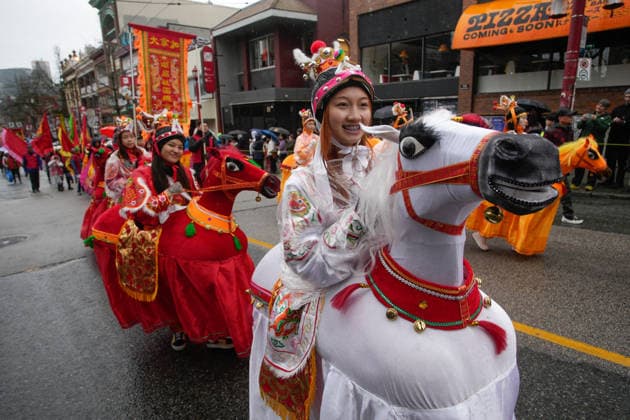 (260223) -- VANCOUVER, Feb. 23, 2026 -- Performers in horse-shaped costumes march through the street during a Spring Festival parade at Chinatown in Vancouver, British Columbia, Canada, on Feb. 22, 2026. The 52nd annual Vancouver Chinatown Spring Festival Parade was held here on Sunday to celebrate the Chinese Year of the Horse. (Photo by Xinhua) CANADA-VANCOUVER-SPRING FESTIVAL PARADE LiangxSen 