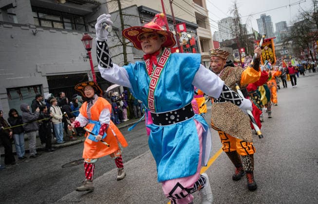 (260223) -- VANCOUVER, Feb. 23, 2026 -- Performers march along the street during a Spring Festival parade at Chinatown in Vancouver, British Columbia, Canada, on Feb. 22, 2026. The 52nd annual Vancouver Chinatown Spring Festival Parade was held here on Sunday to celebrate the Chinese Year of the Horse. (Photo by Xinhua) CANADA-VANCOUVER-SPRING FESTIVAL PARADE LiangxSen 