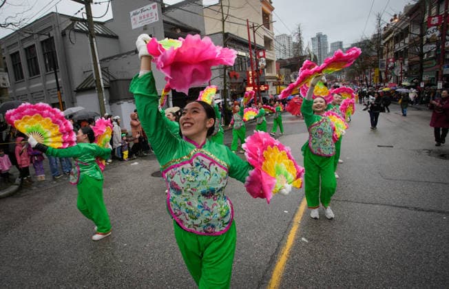(260223) -- VANCOUVER, Feb. 23, 2026 -- Dancers perform along the street during a Spring Festival parade at Chinatown in Vancouver, British Columbia, Canada, on Feb. 22, 2026. The 52nd annual Vancouver Chinatown Spring Festival Parade was held here on Sunday to celebrate the Chinese Year of the Horse. (Photo by Xinhua) CANADA-VANCOUVER-SPRING FESTIVAL PARADE LiangxSen 