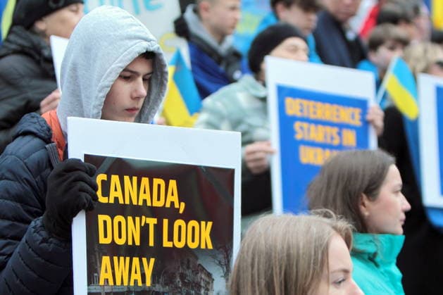 February 22, 2026, Vancouver, Bc, Canada: A woman holding Placard in Global Rally For Ukraine.Global Rally For Ukraine marking four years since Russia s full-scale invasion,taking place on February 22 at 2:00 PM at the vancouver Art Gallery. Vancouver Canada  - ZUMAa223 20260222_zip_a223_005 Copyright: xMazyarxAsadix