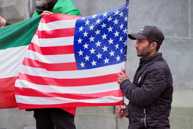 February 22, 2026, Vancouver, Bc, Canada: A man holding an american flag in Global Rally For Ukraine.Global Rally For Ukraine marking four years since Russia s full-scale invasion,taking place on February 22 at 2:00 PM at the vancouver Art Gallery. Vancouver Canada - ZUMAa223 20260222_zip_a223_009 Copyright: xMazyarxAsadix