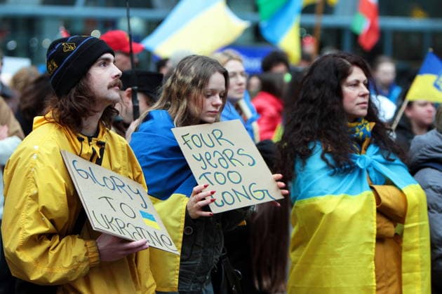 February 22, 2026, Vancouver, Bc, Canada: two people holding Placard in Global Rally For Ukraine.Global Rally For Ukraine marking four years since Russia s full-scale invasion,taking place on February 22 at 2:00 PM at the vancouver Art Gallery. Vancouver Canada - ZUMAa223 20260222_zip_a223_022 Copyright: xMazyarxAsadix