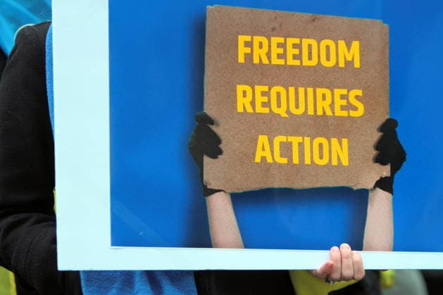 February 22, 2026, Vancouver, Bc, Canada: A woman holding Placard in Global Rally For Ukraine.Global Rally For Ukraine marking four years since Russia s full-scale invasion,taking place on February 22 at 2:00 PM at the vancouver Art Gallery. Vancouver Canada  - ZUMAa223 20260222_zip_a223_045 Copyright: xMazyarxAsadix
