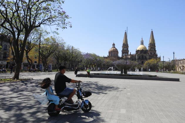 Security measures in Jalisco, Mexico amid volatile situation GUADALAJARA, MEXICO - FEBRUARY 23: A man rides as businesses remain closed in the city of Guadalajara, Jalisco, on February 23, 2026. The Jalisco state government urged residents to remain at home, suspended public transportation, and activated a red alert amid threats to public safety following a military operation targeting the Jalisco New Generation Cartel in the town of Tapalpa, about 130 kilometers (80 miles) south of Guadalajara, the capital of Jalisco state. Stringer Anadolu Guadalajara Mexico. Editorial use only. Please get in touch for any other usage.  Copyright: x2026xAnadoluxStringerx