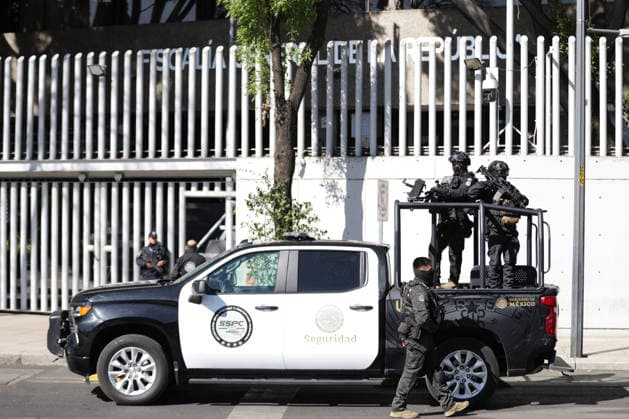 (260223) -- MEXICO CITY, Feb. 23, 2026 -- Security personnel guard on a street in Mexico City, Mexico, Feb. 23, 2026. Retaliation attacks from the Jalisco New Generation Cartel have left 27 security personnel dead, Mexico s Secretary of Security and Citizen Protection Omar Garcia Harfuch said Monday at a press conference. Mexican military forces launched an operation on Sunday and killed the Jalisco New Generation Cartel leader Nemesio Oseguera Cervantes, alias El Mencho. Members of cartels have set fire to cars and commercial facilities, and blocked roads. Some states closed schools on Monday. (Photo by Francisco Canedo Xinhua) MEXICO-MEXICO CITY-CARTEL-OPERATION-SECURITY FuxLangxisike¡¤kanieduo 