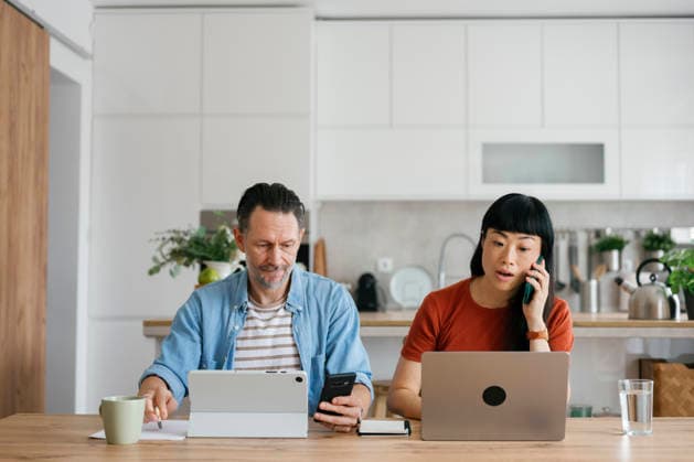 Couple sitting at home working together using laptop and tablet model released, Symbolfoto property released, FLMZF02770