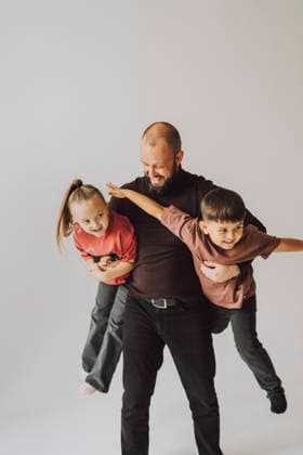 Father playing with children and hugging them in studio model released, Symbolfoto property released, VBUF00745