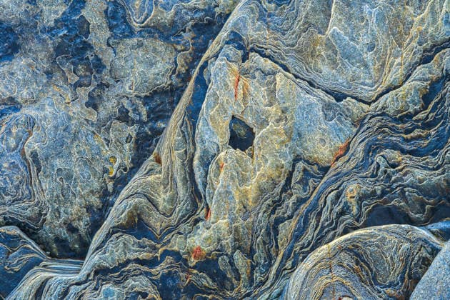 Cliff rock texture with natural geological patterns Close-up of rugged cliff rocks showcasing intricate geological patterns and textures. The natural formations create a unique visual tapestry, ideal for backgrounds and designs. Model Released JuanLopez_ID33931_1194701_011 Copyright: xJuanxLopezx RECORD DATE NOT STATED
