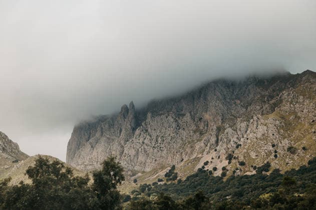 Creative Highlights World Dramatic limestone peaks with low clouds in Serra de Tramuntana Sa Calobra, Balearic Islands, Spain R_EPZT260301-1974970-01