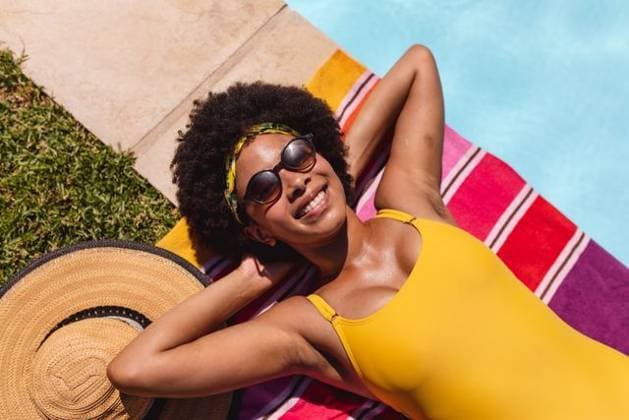 Mixed race woman sunbathing by pool on a sunny day smiling Mixed race woman sunbathing by pool on a sunny day smiling. Hanging out and relaxing outdoors in summer., model released, , property released, Cape Town, South Africa, 14.01.2021, 1404893.jpg, people,mixed race,woman,sunbathing,pool,sunny day,smiling,hanging,relaxing,outdoors,summer,beautiful,vacation,happy,outdoor,lifestyle,leisure,water,travel,young,cheerful,sky,green,fun,happiness,park,sunny,beach,people,mixed,race,day Young Adult,Woman,Female,Black
