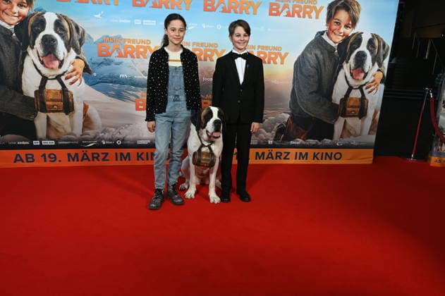 Actors Alma Büchenbacher, Paco von Wyss as Georg with St. Bernard Barry come to the film premiere of Mein Freund Barry at the Cinedom in Cologne