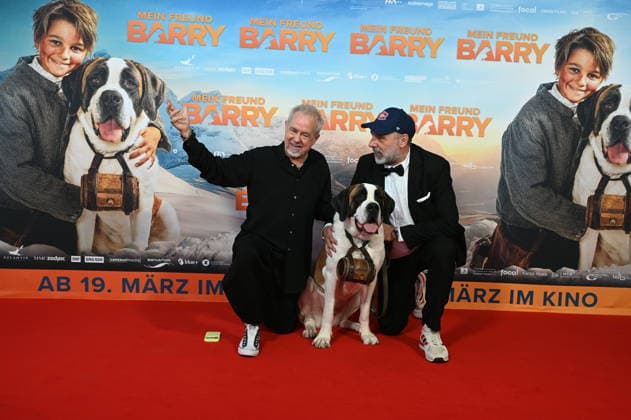 Musician Helmut Zerlett, St. Bernard Barry and director Markus Welter , l r, attend the premiere of the film Mein Freund Barry at the Cinedom in Cologne