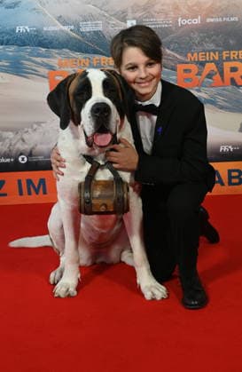 Actor Paco von Wyss with the Swiss Georg and his St. Bernard dog Barry attends the premiere of the film Mein Freund Barry at the Cinedom in Cologne