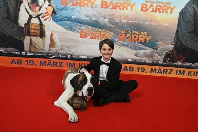 Actor Paco von Wyss with the Swiss Georg and his St. Bernard dog Barry attends the premiere of the film Mein Freund Barry at the Cinedom in Cologne