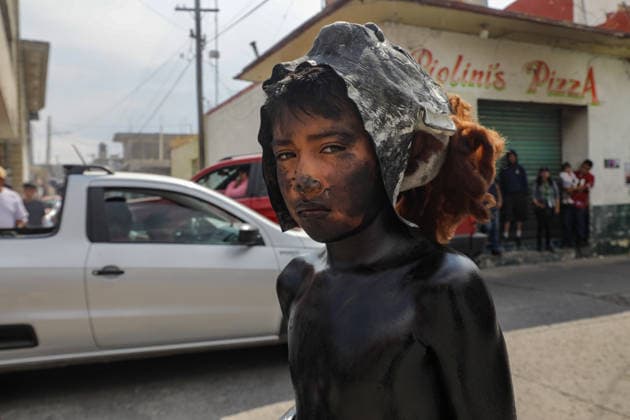 Traditional Xinacates Festival in San Nicolas de Los Ranchos A boy whit his body panted walking on the streets during the traditional Xinacates festival, also known as the Festival of the Painted, where they perform dances as an offering for the start of the crops and to obtain a good harvest in the municipality of San Nicolas de los Ranchos located on the slopes of the Popocatepetl volcano. on March 8, 2026 in San Nicolas de Los Ranchos, Mexico. (Photo by Ian Robles Eyepix Group) Copyright: xIanxRobles xEyepixxGroupx EL_08032026_177763JPEG