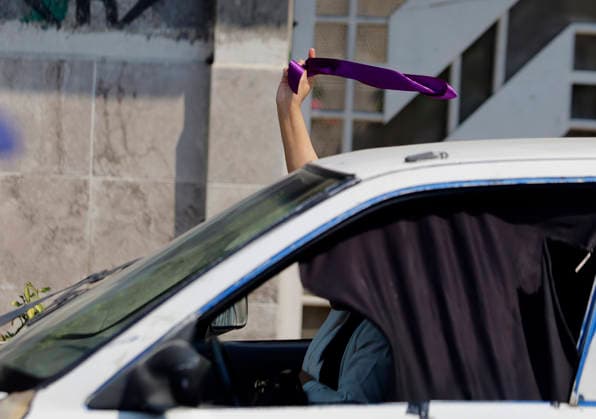March 8, 2026, ChimalhuacaN, State Of Mexico, Mexico: A woman in a car displays a purple scarf in support of mothers and relatives of victims of disappearance and femicide, who are marching toward the municipal seat of Chimalhuacan in the State of Mexico to demand justice and punishment for the perpetrators, on the occasion of International Women s Day in Mexico. According to the United Nations, International Women s Day is commemorated in many countries around the world. When women from all continents, often separated by national borders and ethnic, linguistic, cultural, economic and political differences, come together on this day, they can contemplate a tradition of no less than ninety years of struggle for equality, justice, peace and - ZUMAs197 20260308_aaa_s197_501 Copyright: xGerardoxVieyrax