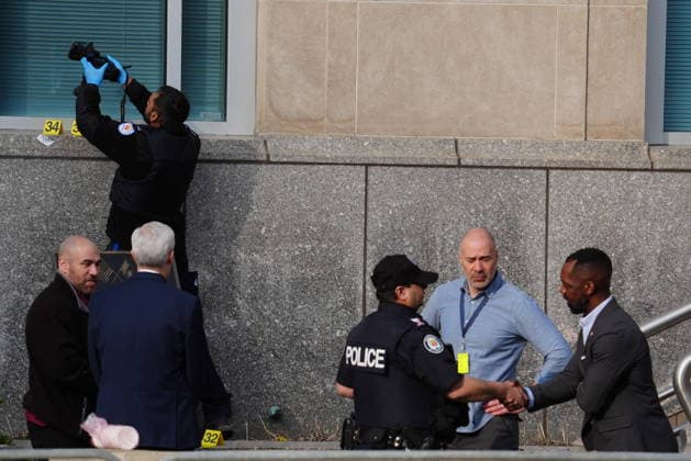 March 10, 2026, Toronto, On, CANADA: A Toronto police officer speaks with consulate officials as forensic officer photographs bullet impact marks at the front U.S. consulate in Toronto on Tuesday March 10, 2026. Toronto CANADA  - ZUMAc35_ 20260310_zaf_c35_011 Copyright: xFrankxGunnx
