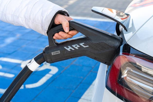 Erkheim, Bavaria, Germany - March 10, 2026: A hand connects an electric car to a fast-charging plug. The photo shows how easy it is to use modern charging technology in everyday life for climate-friendly mobility.