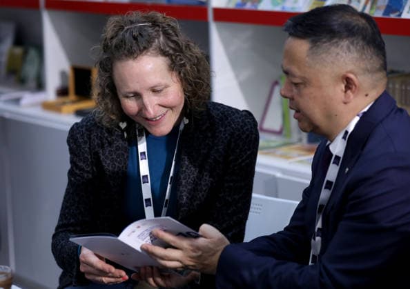 (260311) -- LONDON, March 11, 2026 -- People talk at the China Pavilion of the 2026 London Book Fair in London, Britain, March 10, 2026. At Olympia London, where the 2026 London Book Fair opened Tuesday, the China pavilion stands out not merely for its expansive footprint, but for the comprehensive publishing ecosystem it showcases. The Chinese publishing delegation has arrived with an impressive portfolio of over 4,000 titles and a packed schedule of more than 40 events. Spanning the three-day fair, the agenda ranges from high-profile new book launches and author talks to rights exchanges and industry forums. TO GO WITH Feature: Two-way street -- China s delegation highlights cultural synergy, tech fusion at London Book Fair ) BRI