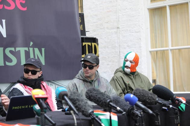 Kneecap s member hold a press conference in Belfast BELFAST, NORTHERN IRELAND - MARCH 11: Kneecap s Mo Chara, Muhllai Bap, DJ Provai hold a press conference at Conway Mill in Belfast, Northern Ireland on March 11, 2026. The UK government lost its appeal over a judge s decision to dismiss terror charges against Liam Og O hAnnaidh, known as Mo Chara related to allegedly displaying a Hezbollah flag at a concert in London in November 2024. The High Court delivered its judgment in an appeal brought by the Director of Public Prosecutions (DPP) challenging the magistrates’ court ruling that dismissed the case against the band member. Conor Mccaughley Anadolu Belfast Ireland. Editorial use only. Please get in touch for any other usage.  Copyright: x2026xAnadoluxConorxMccaughleyx