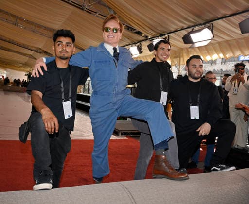 Conan O Brien strikes a pose with the crew during the 98th annual Academy Awards red carpet roll out at Ovation Hollywood in Los Angeles on Wednesday, March 11, 2026. O Brien will host the Oscars for the second consecutive year, airing live on March 15 on ABC.  LAP2026031128 JIMxRUYMEN