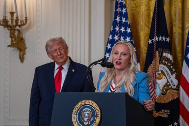 March 12, 2026, Washington, Dc, United States: US President DONALD TRUMP poses with US bobsledder KAILLIE ARMBRUSTER HUMPHRIES, who holds her two bronze medals from the Milano Cortina 2026 Winter Olympic Games, after presenting him with an Ikkos Award during a WomenÃ¢â‚¬â ¢s History Month event in the East Room of the White House in Washington, DC, on March 12, 2026. The Ikkos Award allows Team USA medalists to recognize individuals who supported them on their journey to the Olympic Games. Washington United States - ZUMAl312 20260312_znp_l312_025 Copyright: xAndrewxLeydenx