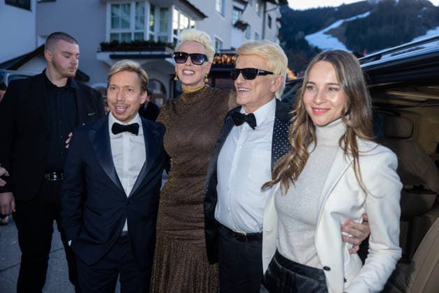 Datum: 13.03.26 Ort: Kitzbühel Im Bild: Helmut Werner, Brigitte Nielsen, Heino, Nicole Werner Er ist Kult blonde Haare, schwarze Sonnenbrille und eine unverwechselbare Jahrhundertstimme: Heino (87) blickt auf eine fast 70-jährige Karriere zurück. Doch nur wenige kennen die Geschichte hinter seiner berühmten dunklen Brille. Der Sänger, der bürgerlich Heinz Georg Kramm heißt, hat in seinem Leben über 55 Millionen Tonträger verkauft. Ob Schlager, Pop, Heavy Metal, Ballermann, Rap oder Klassik kaum ein Genre blieb ihm fremd. Bis heute steht der Kultstar auf der Bühne: Er tritt bei großen Festivals wie dem Parookaville vor Zehntausenden Fans genauso selbstverständlich auf wie bei klassischen Kirchenkonzerten, etwa in der xchristian esslerx