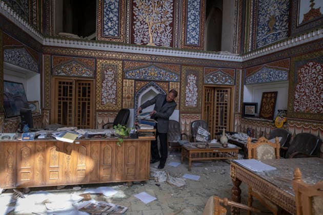 Damaged Historic Fabric Of Isfahan Amid U.S.-Israeli Attacks An Iranian official picks up documents at a historical site damaged by the force of an explosion wave from a military operation near the Provincial Governor s Office in Isfahan, Iran, on March 11, 2026. The site is located 450 km (280 miles) south of Tehran and was built a hundred meters from the city s historic fabric. Tehran Iran  Copyright: xMortezaxNikoubazlx originalFilename: nikoubazl-damagedh260311_npU3l.jpg