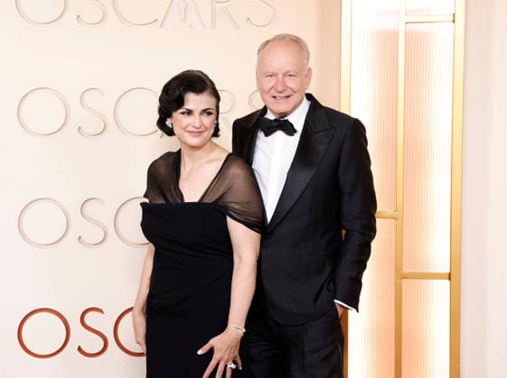 (L-R) Megan Everett-Skarsgard and Stellan Skarsgard arrive on the red carpet for the 98th annual Academy Awards in the Hollywood section of Los Angeles on Sunday, March 15, 2026. Conan O Brien will host the Oscars for the second consecutive year.  LAP20260315577 JOHNxANGELILLO