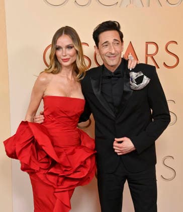 Georgina Chapman and Adrien Brody arrive on the red carpet for the 98th annual Academy Awards in the Hollywood section of Los Angeles on Sunday, March 15, 2026. Conan O Brien will host the Oscars for the second consecutive year.  LAP20260315233 JIMxRUYMEN