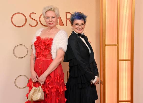 Gigi Williams (right) and guest arrive on the red carpet for the 98th annual Academy Awards in the Hollywood section of Los Angeles on Sunday, March 15, 2026. Conan O Brien will host the Oscars for the second consecutive year.  LAP20260315305 JIMxRUYMEN