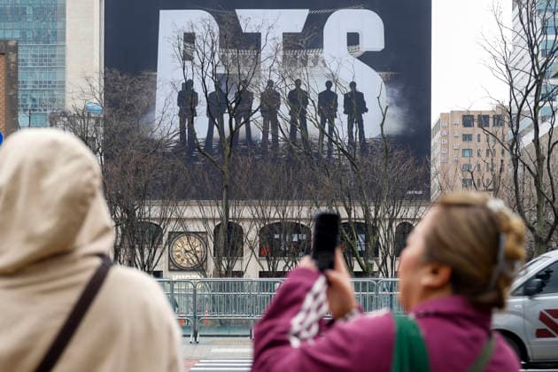 Fans of the K-pop group BTS pose for commemorative photos decorated with promotional material for the upcoming BTS concert in Seoul, South Korea, March 18, 2026. BTS is scheduled to perform their comeback concert, BTS THE COMEBACK LIVE: ARIRANG, at Gwanghwamun Square on March 21, 2026. Matrix Images Jung Ui-Chel 