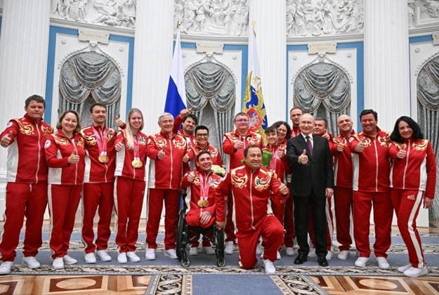 Russia Putin Paralympic Athletes 9126934 19.03.2026 Russian President Vladimir Putin poses for a group photo with participants during a state awards ceremony for the Russian medalists of the Milano Cortina 2026 Winter Paralympic Games at the Kremlin in Moscow, Russia. Sergey Bobylev Sputnik Moscow Russia  Copyright: xSergeyxBobylevx