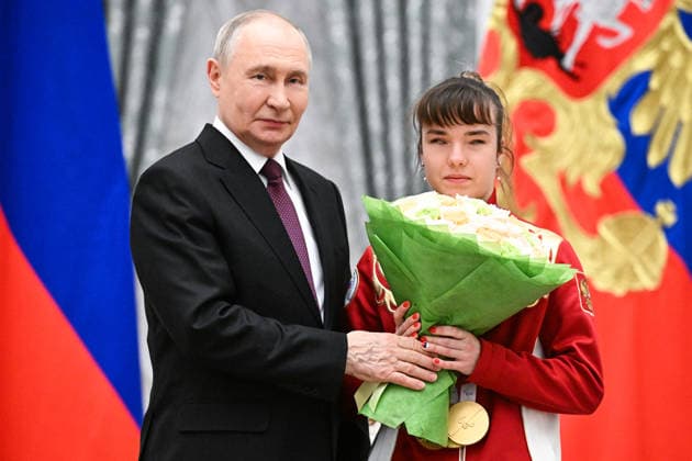 Russia Putin Paralympic Athletes 9126964 19.03.2026 Russian President Vladimir Putin poses with Paralympic champion in the para cross-country skiing women s sprint classic vision impaired, 10km interval start classic VI and 20km interval start free VI, Anastasiia Bagiian, awarded the Order of Friendship, during a state awards ceremony for the Russian medalists of the Milano Cortina 2026 Paralympic Winter Games at the Kremlin in Moscow, Russia. Sergey Bobylev Sputnik Moscow Russia  Copyright: xSergeyxBobylevx