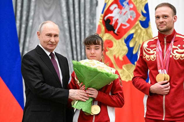 Russia Putin Paralympic Athletes 9126975 19.03.2026 Russian President Vladimir Putin poses with Paralympic champion in the para cross-country skiing women s sprint classic vision impaired, 10km interval start classic VI and 20km interval start free VI, Anastasiia Bagiian, awarded the Order of Friendship, and her guide Sergey Sinyakin, during a state awards ceremony for the Russian medalists of the Milano Cortina 2026 Paralympic Winter Games at the Kremlin in Moscow, Russia. Sergey Bobylev Sputnik Moscow Russia  Copyright: xSergeyxBobylevx
