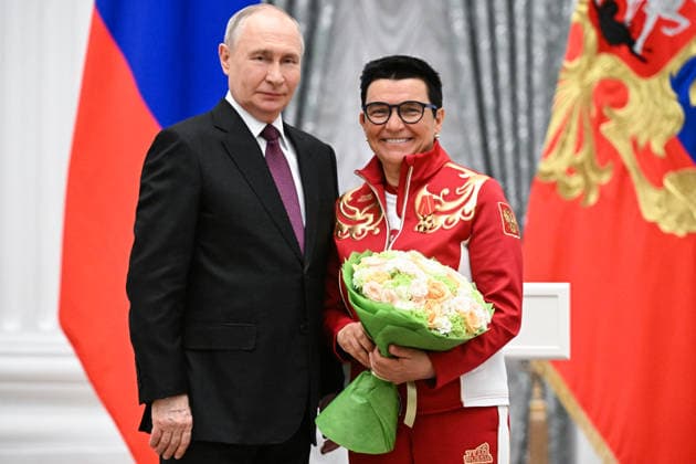 Russia Putin Paralympic Athletes 9127019 19.03.2026 Russian President Vladimir Putin poses with Russian Paralympic team Senior coach in cross-country skiing and biathlon Irina Gromova, awarded the Order of Alexander Nevsky, during a state awards ceremony for the Russian medalists of the Milano Cortina 2026 Paralympic Winter Games at the Kremlin in Moscow, Russia. Sergey Bobylev Sputnik Moscow Russia  Copyright: xSergeyxBobylevx