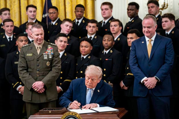 President Donald Trump signs an executive order instructing the Federal Communications Commission and Secretary of Commerce to ensure the Army-Navy Football Game has an exclusive broadcast window during the Commander in Chief s Trophy to the Navy Midshipmen football team during a ceremony in the East Room of the White House in Washington, DC on Friday, March 20, 2026. The award is presented annually to the winner of the football competition between the Navy, Air Force and Army. Navy has won the trophy back to back years and 13 times over the last 23 years.  WAP202603201160 BONNIExCASH