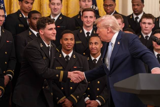 March 20, 2026, Washington, District Of Columbia, USA: President DONALD TRUMP interacts with a player on the Navy Midshipmen football team during an event in the East Room of the White House. Washington USA - ZUMAs365 20260320_znp_s365_010 Copyright: xJoeyxSussmanx