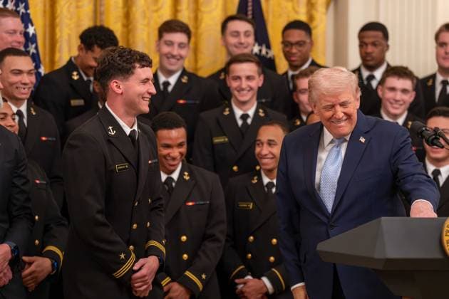 March 20, 2026, Washington, District Of Columbia, USA: President DONALD TRUMP interacts with a player on the Navy Midshipmen football team during an event in the East Room of the White House. Washington USA  - ZUMAs365 20260320_znp_s365_012 Copyright: xJoeyxSussmanx