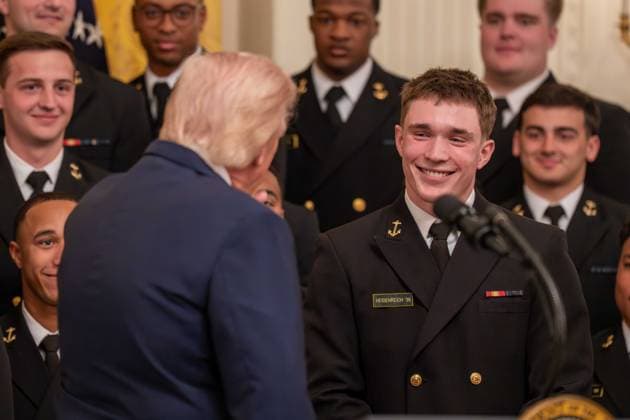 March 20, 2026, Washington, District Of Columbia, USA: President DONALD TRUMP interacts with a player on the Navy Midshipmen football team during an event in the East Room of the White House. Washington USA  - ZUMAs365 20260320_znp_s365_013 Copyright: xJoeyxSussmanx