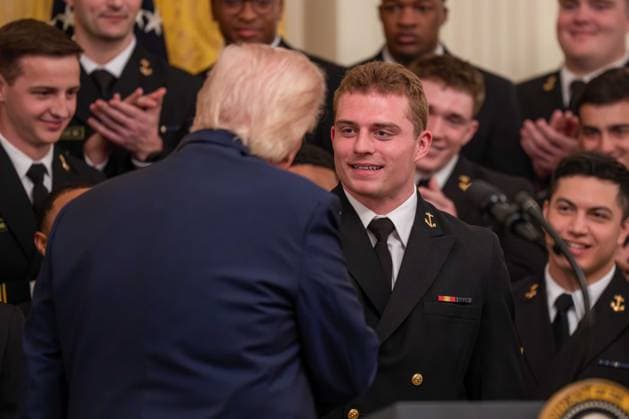 March 20, 2026, Washington, District Of Columbia, USA: President DONALD TRUMP interacts with a player on the Navy Midshipmen football team during an event in the East Room of the White House. Washington USA - ZUMAs365 20260320_znp_s365_019 Copyright: xJoeyxSussmanx