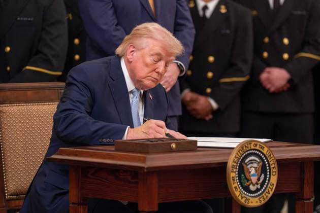 March 20, 2026, Washington, District Of Columbia, USA: President DONALD TRUMP signs an executive order to reserve a four hour block on the second Saturday in December for the Army Navy football game during an event in the East Room of the White House Washington USA - ZUMAs365 20260320_znp_s365_021 Copyright: xJoeyxSussmanx