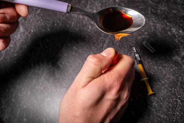 Bavaria, Germany March 20, 2026: A spoon containing a heated substance is held over the flame of a lighter, while a syringe lies nearby. The image illustrates heroin use, the associated health risks, and the addiction resulting from drug abuse. *** Ein Löffel mit erhitzter Substanz wird über einer Flamme eines Feuerzeuges gehalten, während eine Spritze bereitliegt. Das Bild verdeutlicht den Konsum von Heroin und die gesundheitlichen Risiken sowie die Abhängigkeit durch Drogenmissbrauch.