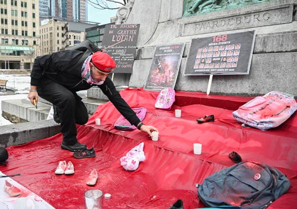March 21, 2026, Montreal, Pq, Canada: A man places a candle at a makeshift memorial during a protest against the U.S. and Israeli war against Iran and Lebanon in Montreal, Saturday, March 21, 2026. Montreal Canada  - ZUMAc35_ 20260321_zaf_c35_077 Copyright: xGrahamxHughesx