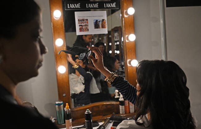 March 21, 2026, Mumbai, Maharashtra, India: A model is seen using a Ray-Ban Meta glasses inside the makeup room at the Lakme Fashion Week (LFW) in Mumbai. Mumbai India - ZUMAs197 20260321_aaa_s197_105 Copyright: xAshishxVaishnavx